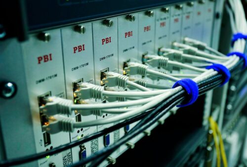 Close-up of network cables plugged into a switch in a server room